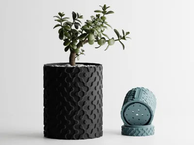 Modern 3D printed wall vase in black with a succulent, showcasing innovative design and eco-friendly materials.